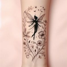 a tattoo on the leg of a woman with flowers and a fairy sitting on it