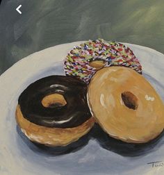 two donuts on a plate with sprinkles