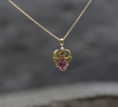 "This Art Nouveau pendant shows the feminine curves we love from this period with bright lime green enamel work and a lovely pink sapphire as the center piece. This is a conversion necklace repurposed from a stickpin. The chain is sold separately. Gemstones: Pink Sapphire Weight: 1=0.58 cts estimated Measurements: 6.2 x 4 x 2.9 mm Cut: Oval Faceted Color: Bright Hot Pink Clarity: eye clean Gemstones: Natural Seed Pearl Measurements: 1.8 mm Shape: Round Color: white Chain available upon request a Exquisite Pink Sapphire Jewelry Gift, Exquisite Pink Sapphire Jewelry For Gift, Elegant Hallmarked Pink Sapphire Jewelry, Pink Sapphire Pendant Jewelry, Pink Sapphire Pendant Jewelry As Gift, Pink Sapphire Pendant Necklace As Gift, Pink Sapphire Pendant Necklace For Gift, Elegant Pink Sapphire Gemstone Necklace, Elegant Pink Ruby Necklace