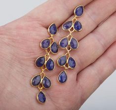 An exquisite piece of artwork, this pair of five-tier swinging sapphire earrings in willow leaflets form would be a nice reward for yourself or a great gift for your mother or best friend.Each one has five layers of sapphire stones set in leaflet shaped, gold plated bezels and laid in a dangling willow branch pattern.1. Stones : sapphire 2. Stone shape and size: each stone is about 10 x 7 mm in pear shape    the top layer has a stone framed with an ear post behind.3. earring total length/width ~ Sapphire Earring, Earring Long, Leaf Earring, Engraved Locket, Willow Leaf, Sapphire Stones, Oval Locket, September Birthday, Photo Locket Necklace