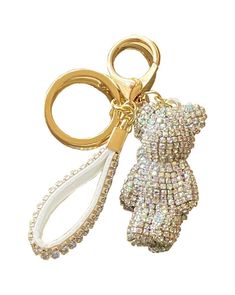 a key chain with a teddy bear on it's side and some beads hanging from the end