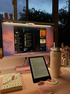 a computer monitor sitting on top of a desk next to a keyboard and mouse pad