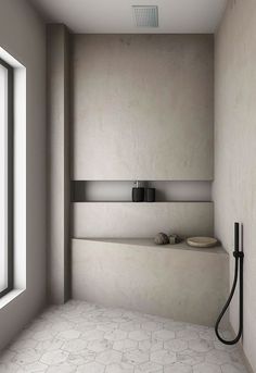 a bathroom with a shower, sink and window