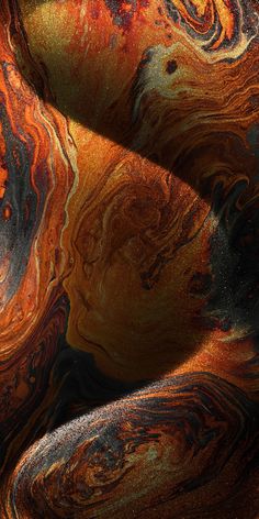 an orange and black abstract background with lots of swirly patterns on it's surface