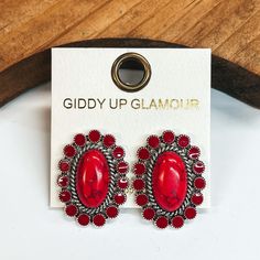 Dark red concho earrings outlined by silver  detailing and dark red circles around.  Taken on a white background and leaned up against a brown block. Concho Earrings, Giddy Up Glamour, Red Stone, Phone Ring, Post Earrings, 1 Inch, Gemstone Rings, Dye, Gemstones