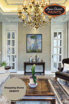 a living room filled with furniture and a chandelier hanging over the top of a coffee table