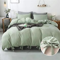 an image of a bedroom setting with green comforter and pillows on the bed in it