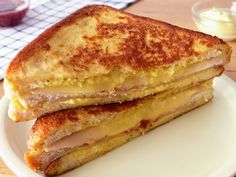 two grilled cheese sandwiches stacked on top of each other