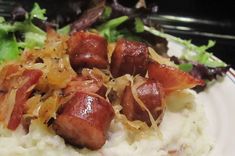 a white plate topped with mashed potatoes and meat