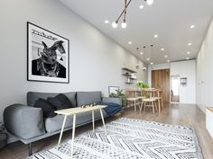 a living room filled with furniture next to a wooden table and stairs in front of a white wall