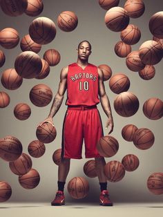 a man standing in front of many basketballs