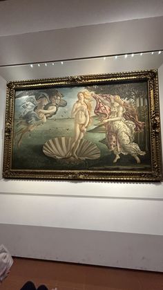 a painting on display in a museum with people looking at it