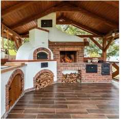 an outdoor kitchen with wood burning in the oven