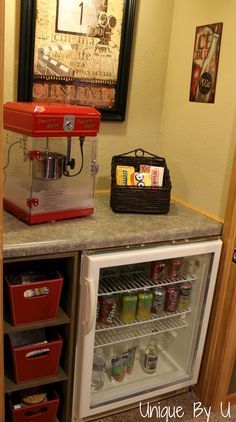 a small refrigerator with an icebox and mini fridge underneath it in the corner of a kitchen