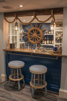 two stools in front of a bar with a steering wheel on the wall