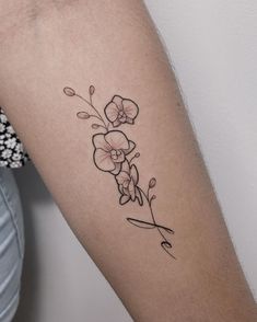 a woman's arm with a flower tattoo on the left side of her arm