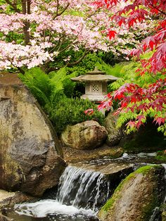 a japanese garden shower curtain with waterfall and rocks in the foreground, surrounded by colorful trees