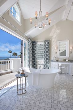 a bathroom with a large bathtub and chandelier