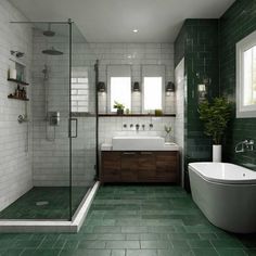 a bathroom with green tile and white fixtures, including a tub, sink, shower, and toilet