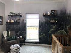 a living room filled with furniture and wallpaper covered in forest design on the walls