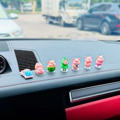 the car dashboard has five little pigs on it