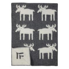 a blanket with white moose on it and a black square in the middle is shown