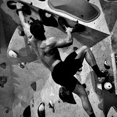 a man climbing up the side of a rock wall