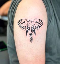 an elephant head tattoo on the arm