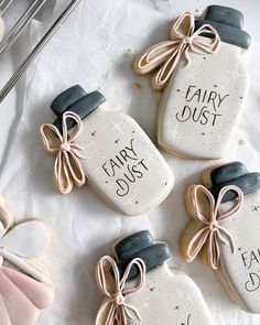 decorated cookies in the shape of mason jars with words fairy dust and fairy dust written on them