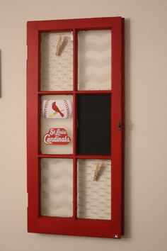 a red window with chalkboard and magnets in it