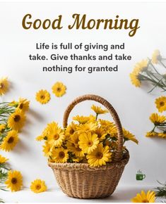 a basket filled with yellow flowers sitting on top of a white table next to daisies