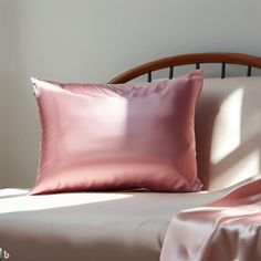 a bed topped with pink sheets and pillows