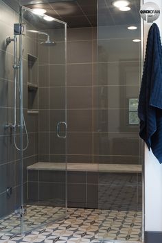 a walk in shower sitting next to a bathtub with a glass door and tiled floor