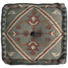 a square rug with an ornate design on it