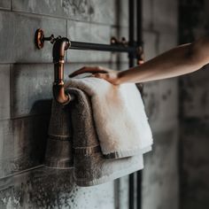 a towel hanging on the wall next to a faucet