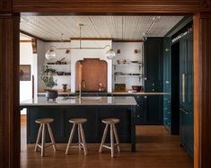 three stools are in front of the kitchen island