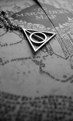 a harry potter necklace on top of a map