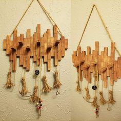 two pieces of art made out of wooden planks hanging from ropes and strings on the wall