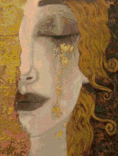 a woman's face is covered in gold and white glitters, with her eyes closed