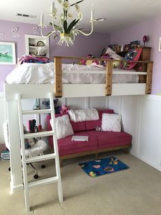 a bunk bed with a futon underneath it and a pink couch under the ladder