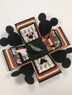 mickey mouse coasters are arranged in the shape of a flower with black and yellow accents