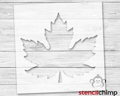 a cutout of a maple leaf on a wooden background with the word stencil chip