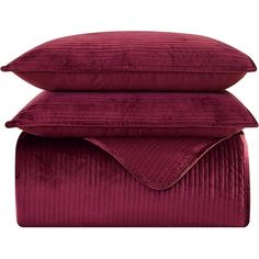 three pillows stacked on top of each other, one with a red blanket and the other in