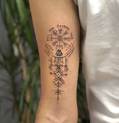 a person with a compass tattoo on their arm