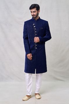 Midnight blue full sleeves layered sherwani crafted in velvet silk with Wildbloom motif thread embroidery using sequin highlights. Paired with an off white Aligadhi pant. - Aza Fashions Blue Sherwani With Zari Work For Winter, Elegant Blue Kurta For Winter, Blue Sherwani With Naqshi Long Sleeve, Blue Sherwani With Naqshi For Festive Occasions, Blue Naqshi Sherwani For Festive Occasions, Blue Long Sleeve Sherwani With Naqshi Detailing, Blue Naqshi Sherwani For Diwali, Blue Sherwani With Naqshi In Traditional Drape, Blue Sherwani With Naqshi And Traditional Drape