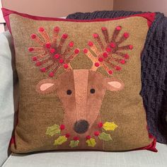 a decorative pillow with a deer's head on it