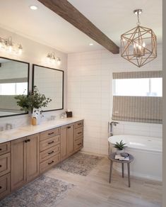 a large bathroom with two sinks and a tub