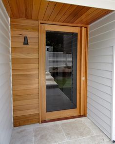 a wooden door is open on the outside of a house