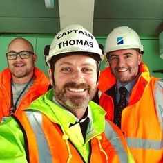 three men in safety vests and hard hats