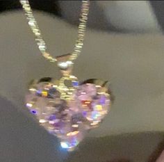 a heart shaped necklace is hanging from the ceiling